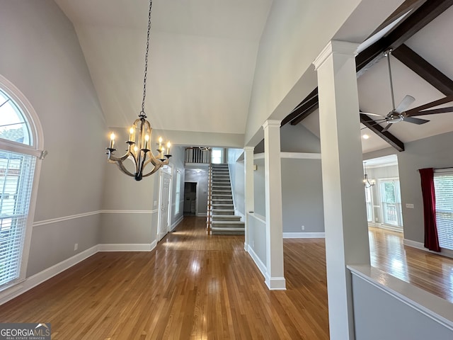 23 Saint Ives Ln, Winder, GA 30680 - unfurnished dining area with wood-type flooring, high vaulted ceiling, baseboards, and stairway