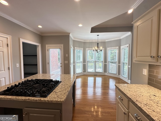 23 Saint Ives Ln, Winder, GA 30680 - kitchen with recessed lighting, an inviting chandelier, black gas cooktop, and wood finished floors
