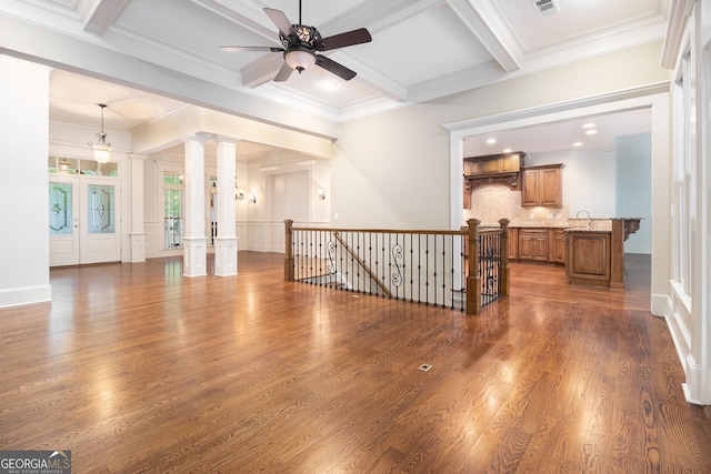 unfurnished living room with a ceiling fan, coffered ceiling, dark wood-style floors, and beamed ceiling