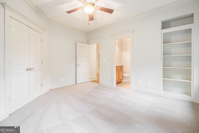 unfurnished bedroom featuring crown molding, connected bathroom, and carpet