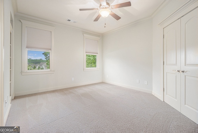 unfurnished bedroom featuring baseboards, carpet flooring, and ornamental molding