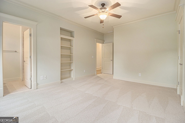 unfurnished bedroom featuring crown molding, baseboards, light carpet, and ensuite bath