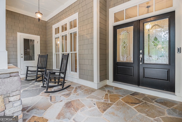 doorway to property featuring a porch and french doors