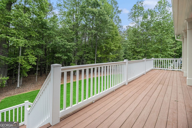 wooden deck featuring a yard
