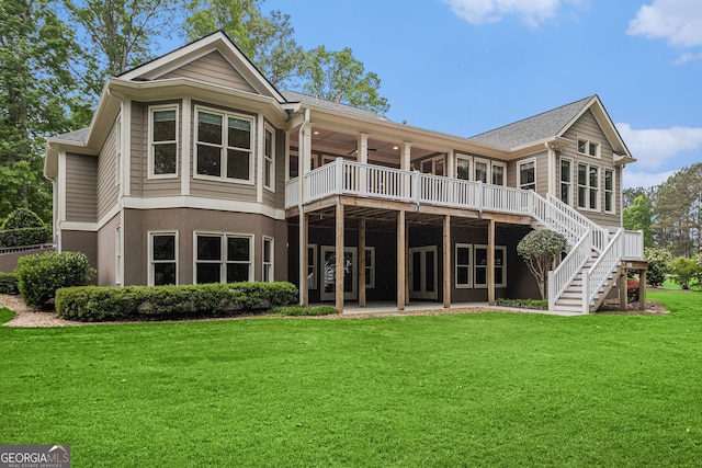back of house with a ceiling fan, a yard, a deck, and stairway