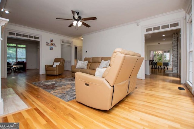 213 Shady Valley Dr, Carrollton, GA 30116 - living area with light wood-style floors, ceiling fan, crown molding, and plenty of natural light