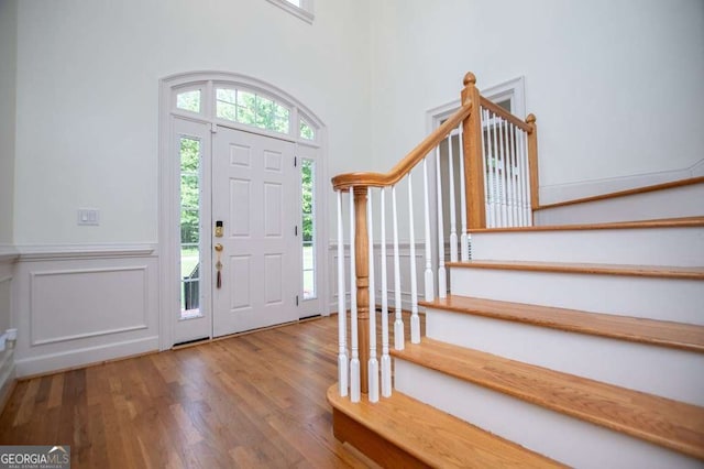 213 Shady Valley Dr, Carrollton, GA 30116 - foyer entrance featuring stairs, wood finished floors, wainscoting, and a decorative wall