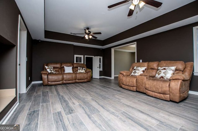 213 Shady Valley Dr, Carrollton, GA 30116 - living room with a ceiling fan, wood finished floors, and a tray ceiling