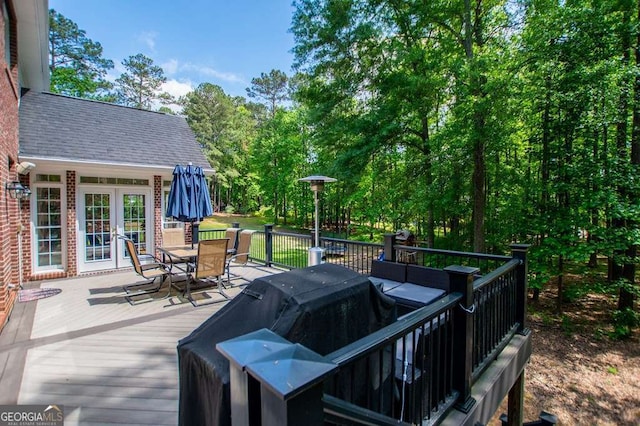 213 Shady Valley Dr, Carrollton, GA 30116 - wooden terrace with outdoor dining space and a grill