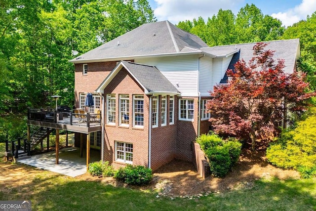 213 Shady Valley Dr, Carrollton, GA 30116 - back of house with stairway, a wooden deck, brick siding, a patio, and a yard