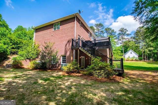 213 Shady Valley Dr, Carrollton, GA 30116 - back of house featuring brick siding, stairway, a deck, and a yard