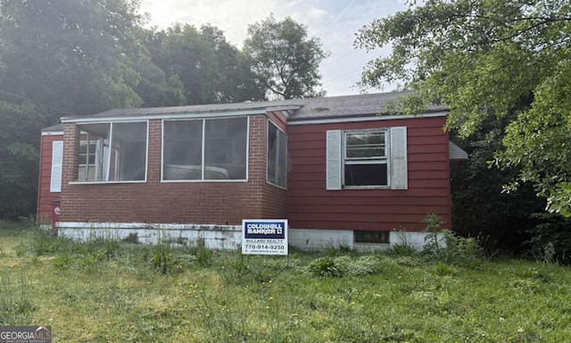 view of side of home featuring brick siding