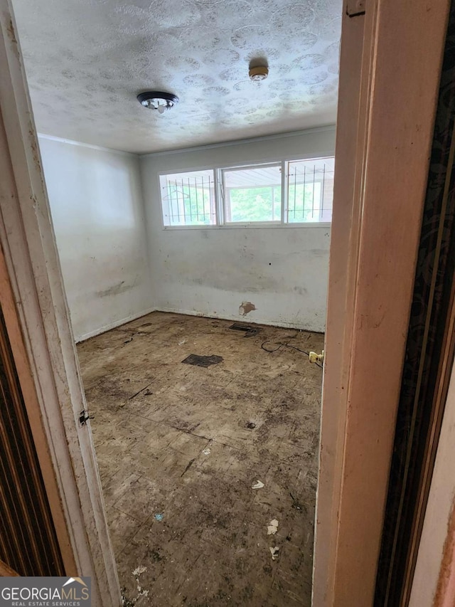 empty room featuring a textured ceiling
