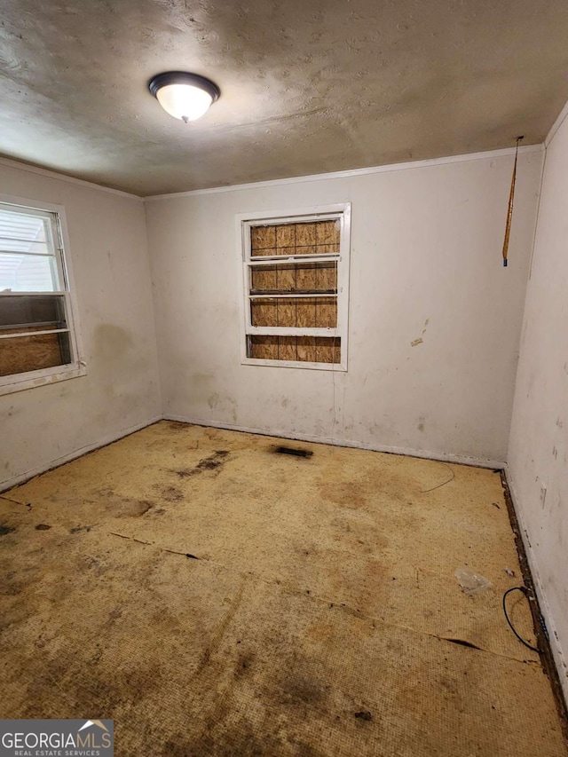unfurnished room with a textured ceiling