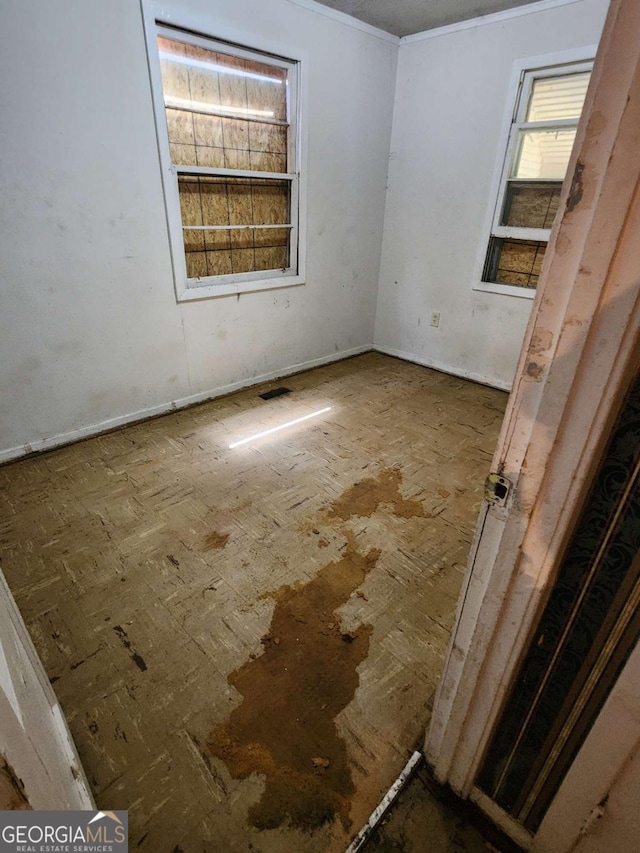 unfurnished room with visible vents