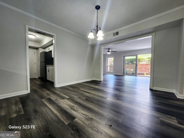 unfurnished dining area featuring visible vents, baseboards, crown molding, and dark wood-style floors