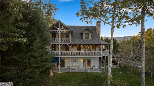 709 Laurel Creek Trl, Blue Ridge, GA 30513 - back of house featuring a yard, a patio, a chimney, and a balcony