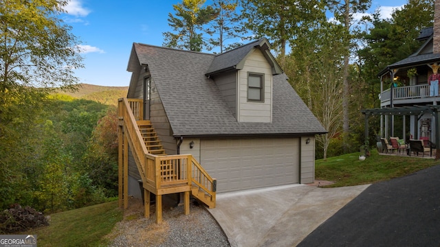 709 Laurel Creek Trl, Blue Ridge, GA 30513 - view of front of home with roof with shingles, a detached garage, a front lawn, and stairway