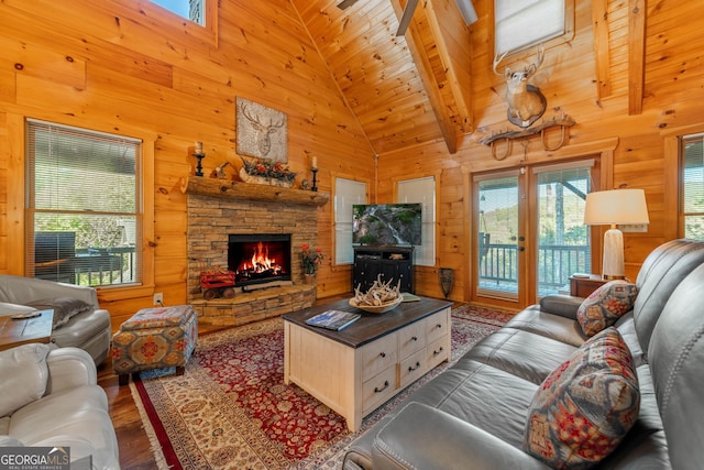 709 Laurel Creek Trl, Blue Ridge, GA 30513 - living area with a healthy amount of sunlight, a stone fireplace, wood walls, and wood finished floors