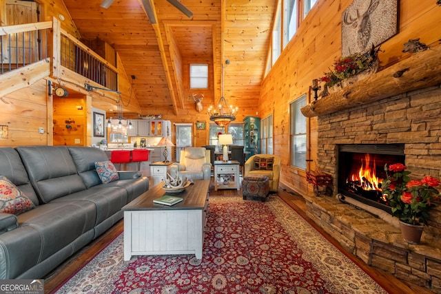 709 Laurel Creek Trl, Blue Ridge, GA 30513 - living room with high vaulted ceiling, wood walls, a wealth of natural light, and wood finished floors