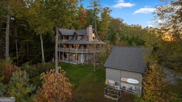 709 Laurel Creek Trl, Blue Ridge, GA 30513 - back of house with a patio, a chimney, a balcony, an outdoor structure, and a yard
