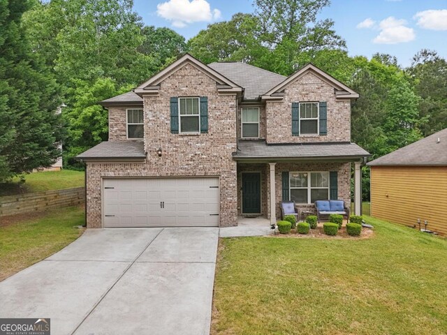 11028 Southwood Dr, Hampton, GA 30228 - view of front of house featuring an attached garage, a front lawn, brick siding, and concrete driveway