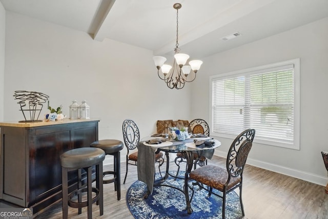 11028 Southwood Dr, Hampton, GA 30228 - dining space with an inviting chandelier, beam ceiling, baseboards, light wood-type flooring, and visible vents