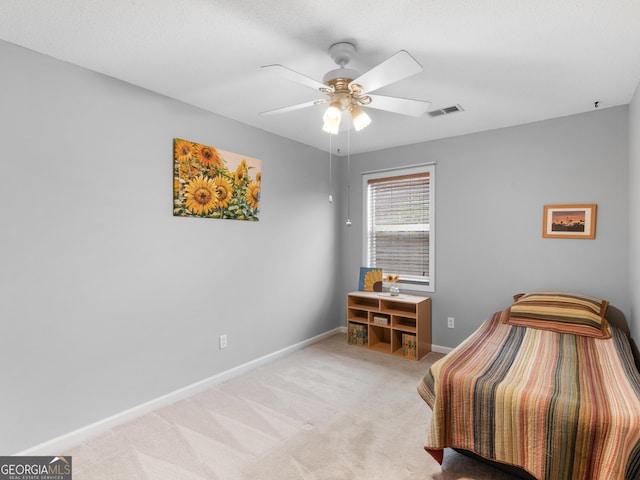 bedroom with baseboards, ceiling fan, light colored carpet, and visible vents