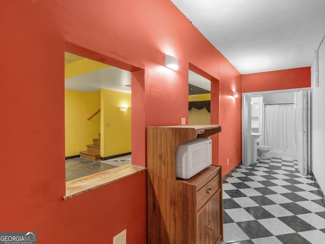 corridor featuring dark floors and stairway