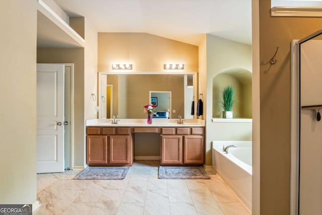 bathroom with a sink, vaulted ceiling, a bath, and marble finish floor
