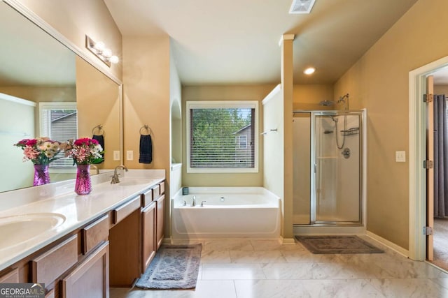 bathroom with visible vents, a sink, a bath, and a stall shower