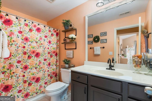 full bathroom featuring vanity, toilet, tile patterned floors, a shower with shower curtain, and visible vents