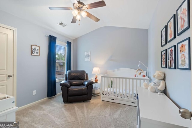 carpeted bedroom with a crib, a ceiling fan, baseboards, vaulted ceiling, and visible vents