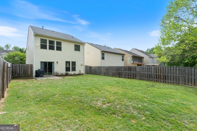 back of house featuring a fenced backyard, a lawn, and a patio area