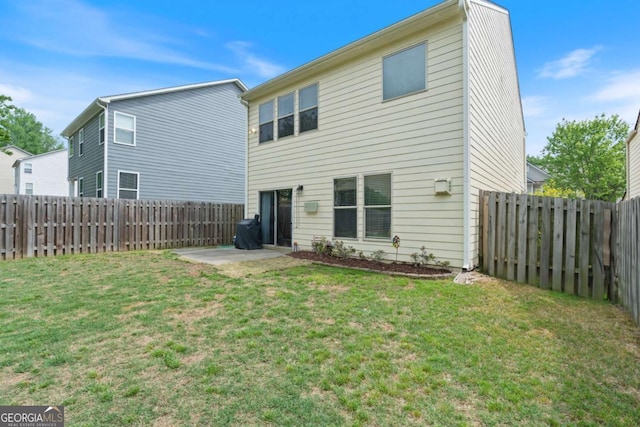 back of house with a patio, a fenced backyard, and a yard