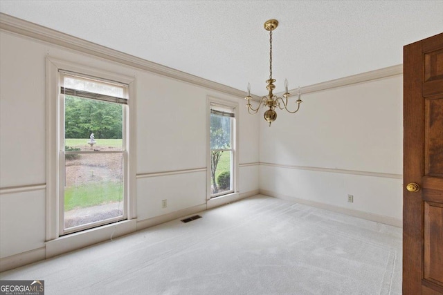 115 Old Ridge Rd, Macon, GA 31211 - empty room featuring carpet flooring, an inviting chandelier, a textured ceiling, visible vents, and ornamental molding