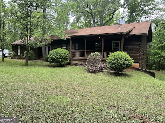 rear view of property with a lawn and a porch