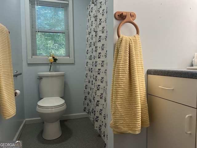 full bath featuring toilet and baseboards