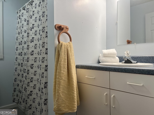 bathroom with vanity and a shower with shower curtain