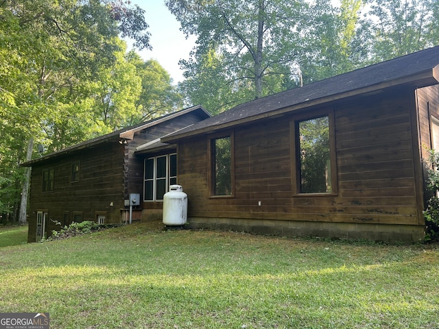 rear view of property with a lawn
