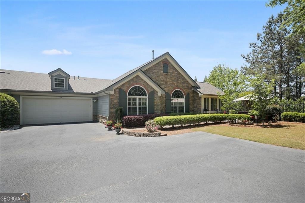 104 Highlands Ridge Pl Unit 1, Smyrna, GA 30082 - ranch-style home with an attached garage, a front yard, driveway, and stone siding