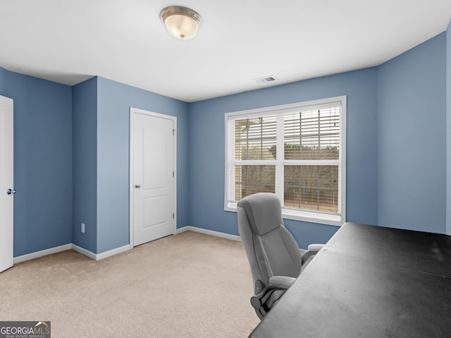 office with baseboards, visible vents, and carpet