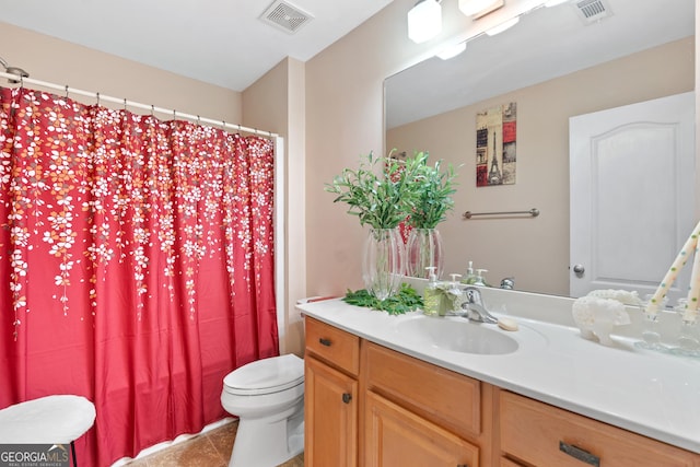 bathroom with vanity, tile patterned floors, toilet, and visible vents