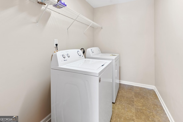 laundry room featuring baseboards, laundry area, and washer and dryer