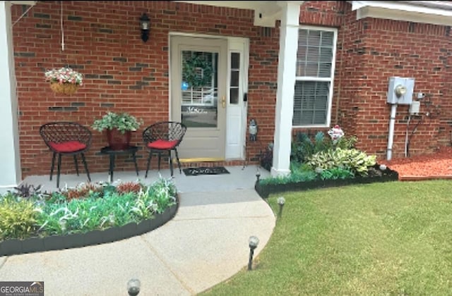 entrance to property featuring brick siding