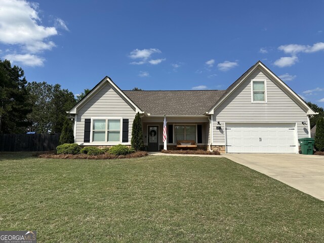 20 Wagon Trl, Mansfield, GA 30055 - view of front of home featuring fence, an attached garage, a shingled roof, a front lawn, and concrete driveway