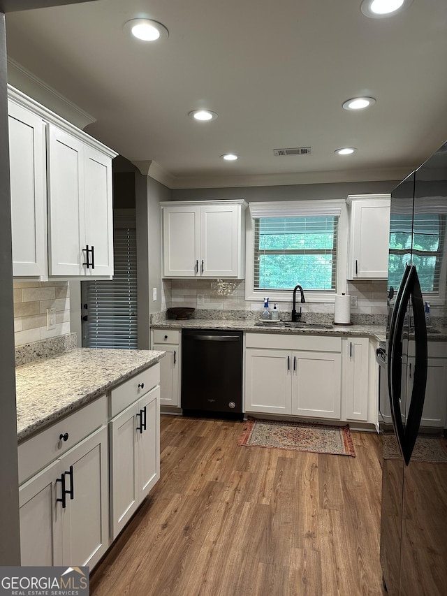 20 Wagon Trl, Mansfield, GA 30055 - kitchen featuring visible vents, white cabinets, a sink, backsplash, and black appliances