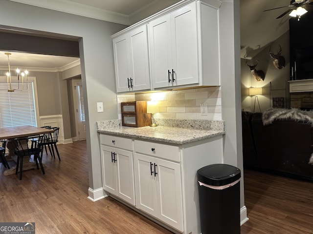 20 Wagon Trl, Mansfield, GA 30055 - kitchen featuring crown molding, wood finished floors, white cabinets, and tasteful backsplash