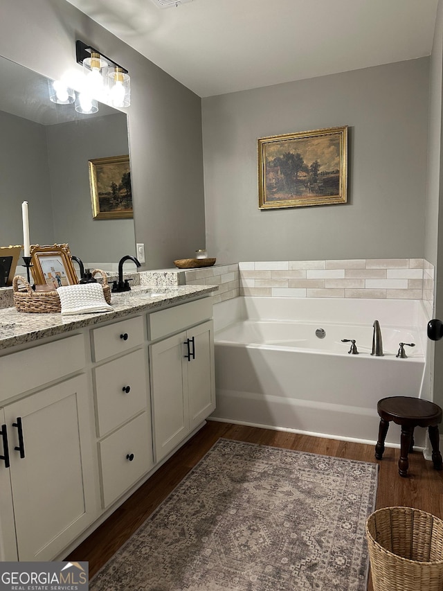 20 Wagon Trl, Mansfield, GA 30055 - bathroom featuring a garden tub, wood finished floors, and vanity