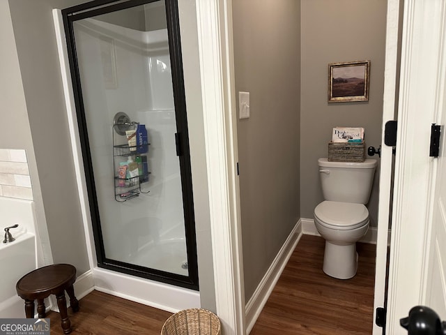 20 Wagon Trl, Mansfield, GA 30055 - bathroom featuring toilet, baseboards, wood finished floors, a bath, and a stall shower